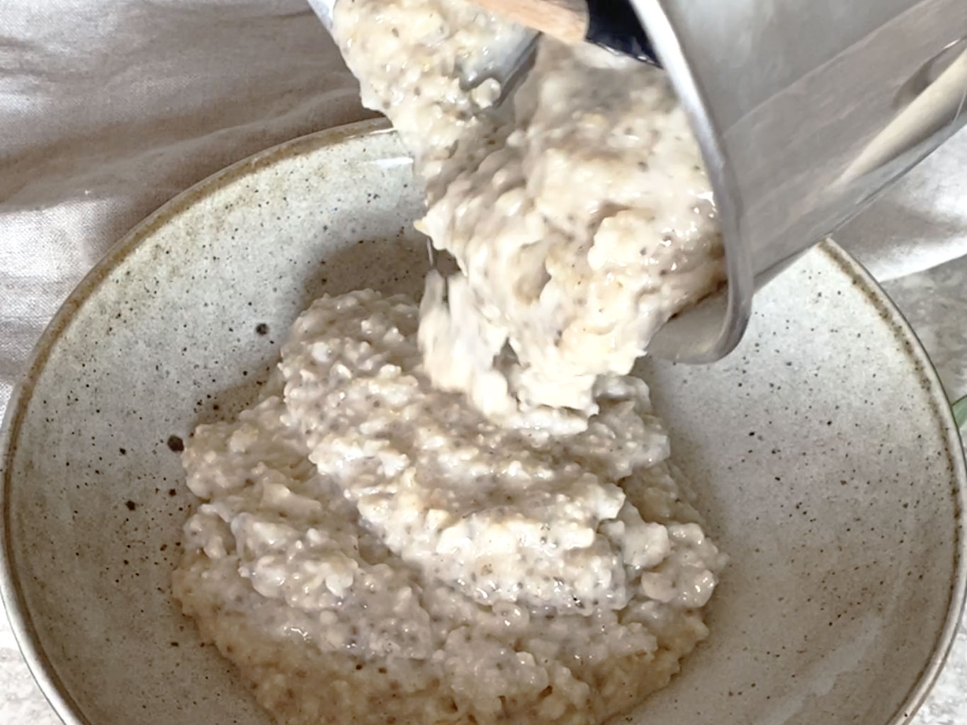 Serving oatmeal into a wide bowl