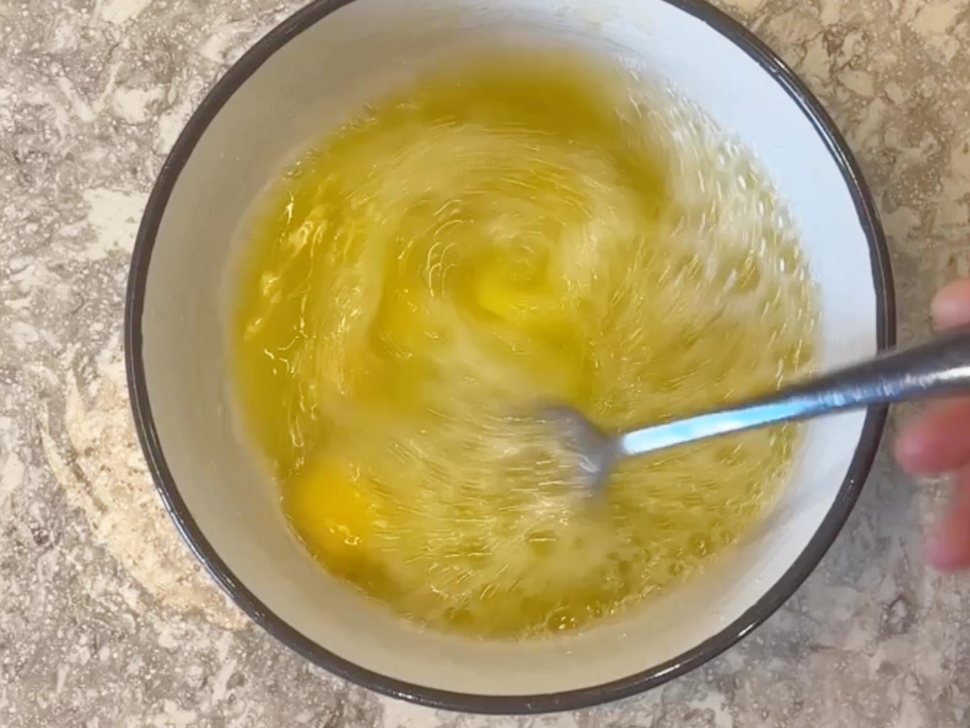 Whisking eggs, water and olive oil