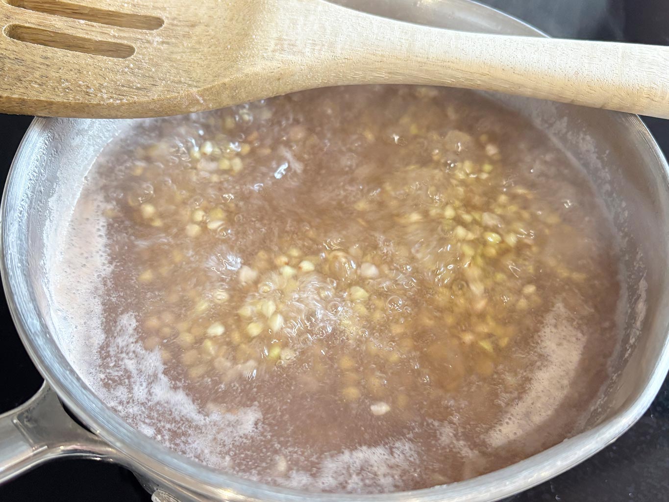 Boil buckwheat groats in a saucepan on medium heat