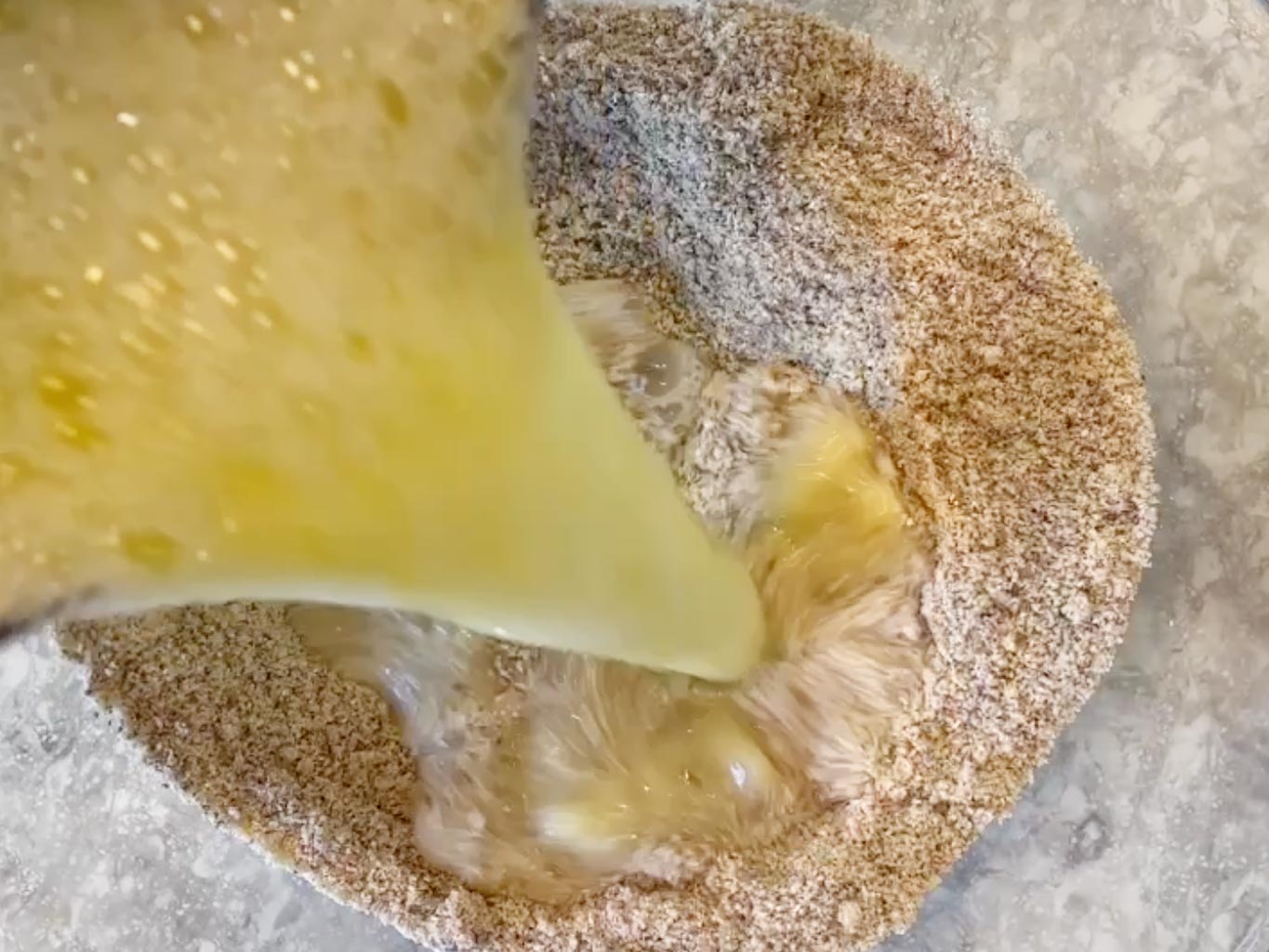 Pouring wet ingredients into dry ingredients