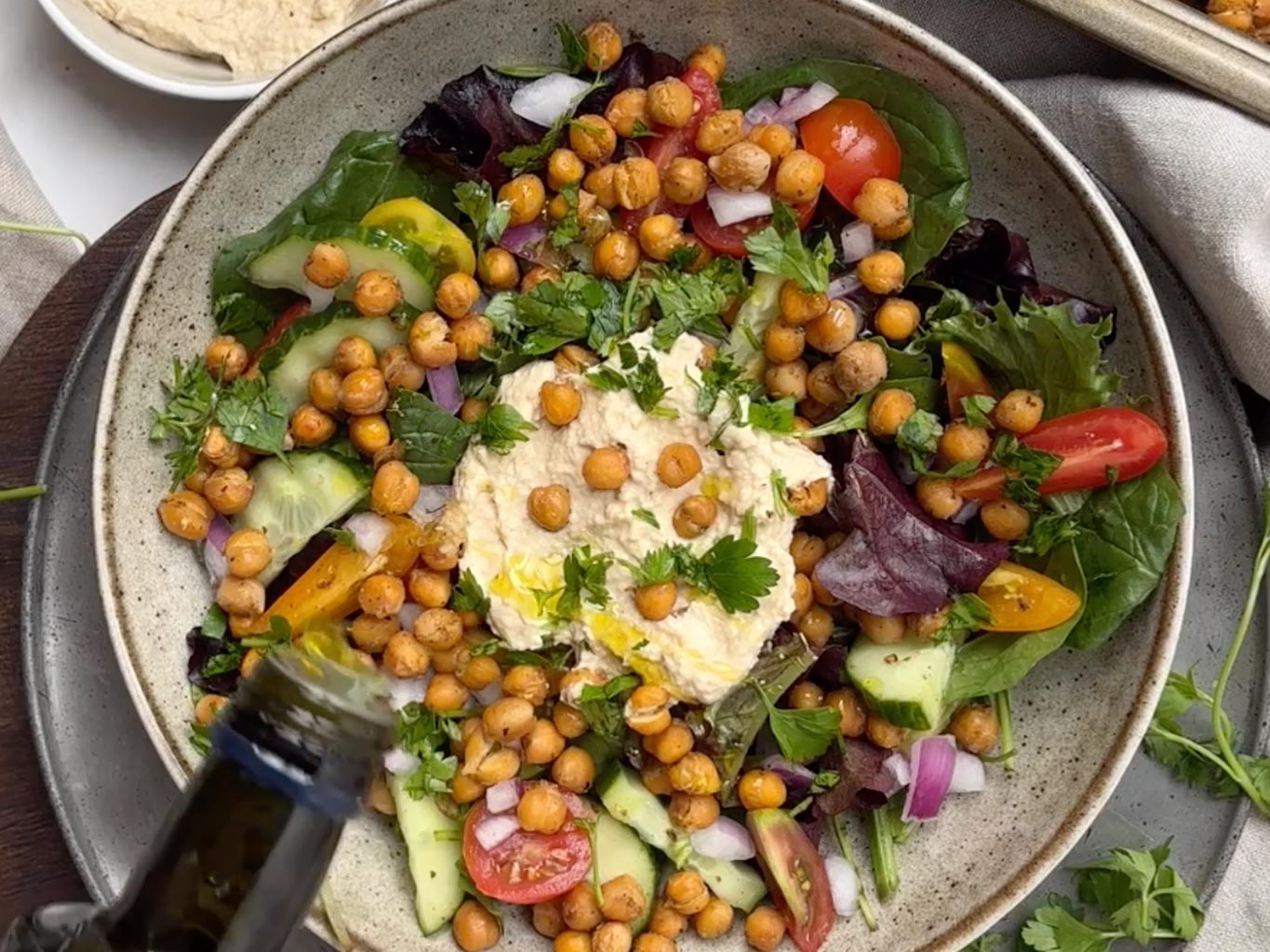 Once the chickpeas are ready, add them to the salad with a generous scoop of hummus in the centre
